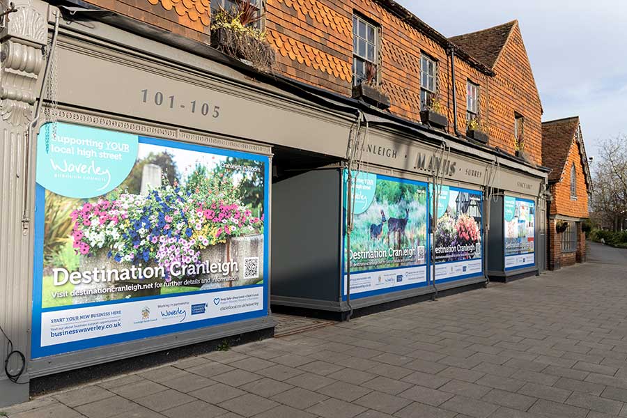 Vinyl window graphics created for the front windows of Manns of Cranleigh by Bluedot Display