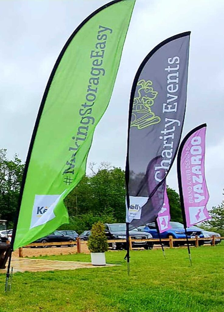 A series of large feather flags created by Bluedot display for an event