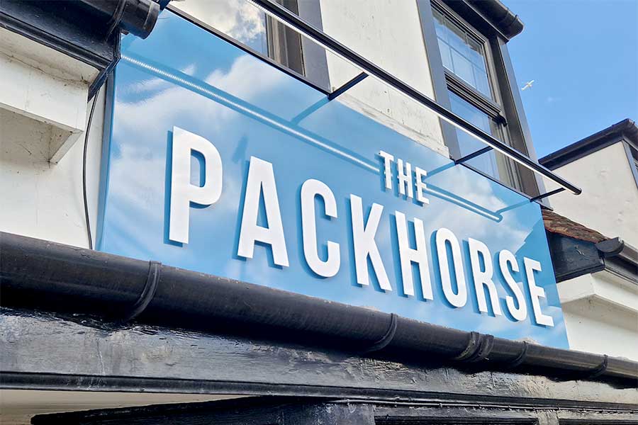 Large blue aluminium fascia tray sign with raised white lettering created by Bluedot Display for the Packhorse pub