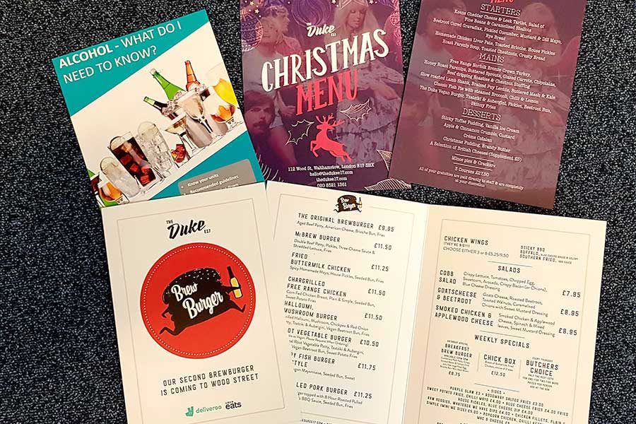 A selection of flyers, brochures, leaflets, and food menu's printed for businesses in Surrey by Bluedot Display Ltd
