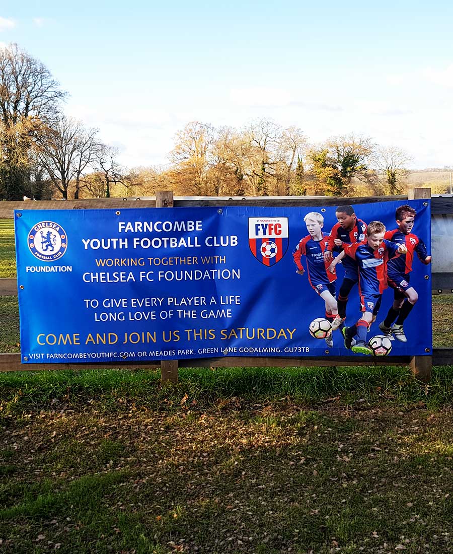 Large PVC banner for Farncombe Youth Football Club and The Chelsea Academy printed and installed by Bluedot Display